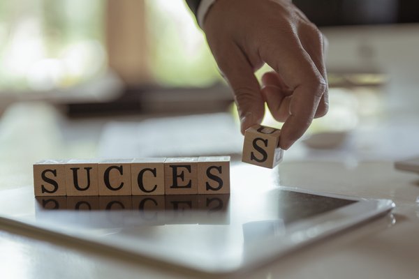 a wooden block that tells of success