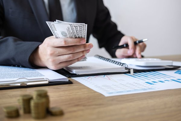 businessman accountant counting money and making