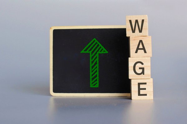 wooden cubes with text wage and chalkboard